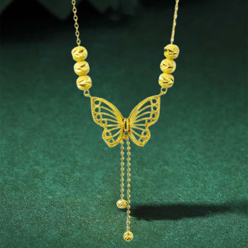 Hjemix | Halskjede med gullfarget sommerfugl med dusker