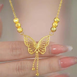 Hjemix | Halskjede med gullfarget sommerfugl med dusker